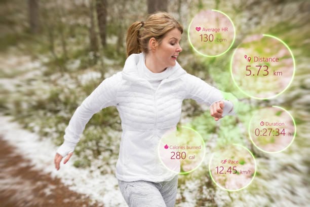 A woman jogging in a snowy park, with digital overlays showing fitness statistics like calories burned, heart rate, distance, and pace.