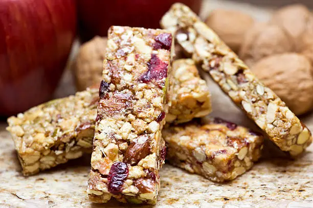 Close-up of homemade granola bars with nuts, dried fruits, and seeds, highlighting their rich essential nutrients like fiber, protein, and healthy fats.